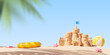 Sand castle on the beach and beach accessories. The concept of holidays with children at sea, travel. Mock up. 3d rendering
