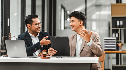 Wall Mural - Two disgusting businessmen Asian lawyer of Indian descent paying attention to mistakes, proposing corrections. Businessman discussing contract policy terms with client, rights of liberty concept.