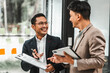 © Phushutter - Two disgusting businessmen Asian lawyer of Indian descent paying attention to mistakes, proposing corrections. Businessman discussing contract policy terms with client, rights of liberty concept.