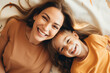 © AI_images - Top view of a mother and her daughter laughing cheerfully