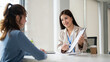 © bongkarn - A professional Asian businesswoman is having a meeting with a female client in the office
