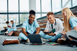 © Drazen - Multiracial group of medical students e-learning on laptop in lecture hall.