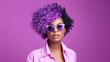 © wolfhound911 - Fashion young african girl black woman wear stylish pink glasses clothes looking at camera isolated on party purple studio background