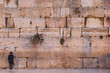 Ultra-orthodox man in black praying alone at the Wailing Wall, Jerusalem