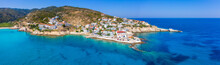 Lovely Greek Fishing Village Of Armenistis In A Quiet Summer Morning. Port With Local Beach In Transparent Clear Water At Ikaria, Greece