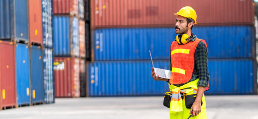 Wall Mural - Professional engineer container cargo foreman in helmets working and using laptop checking stock into container for loading.logistic transport and business industry export