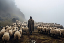 Shepherd Tends A Sheep Flock In The Misty Mountains