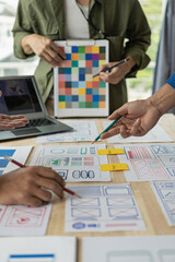 Wall Mural - the web ux ui design team is writing code and layers to customize the smartphone front ux ui display