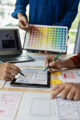 Wall Mural - the web ux ui design team is writing code and layers to customize the smartphone front ux ui display