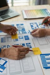 Wall Mural - the web ux ui design team is writing code and layers to customize the smartphone front ux ui display
