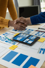 Wall Mural - the web ux ui design team is writing code and layers to customize the smartphone front ux ui display