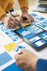 Wall Mural - the web ux ui design team is writing code and layers to customize the smartphone front ux ui display