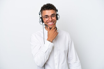 Wall Mural - Telemarketer Brazilian man working with a headset isolated on white background with glasses and smiling