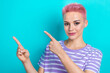 © deagreez - Portrait of pretty positive girl indicate fingers empty space ad blank isolated on turquoise color background