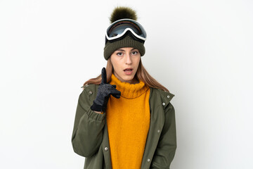 Skier caucasian woman with snowboarding glasses isolated on white background intending to realizes the solution while lifting a finger up