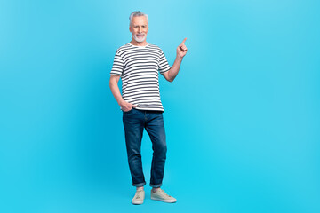 Wall Mural - Full length photo of cheerful stylish man promoter dressed trendy outfit recommend empty space isolated on blue color background