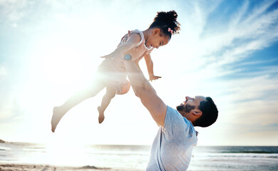 Father lifting child, air and beach with family, travel and freedom outdoor, happiness and ocean with girl and man. Happy people, sunshine and tropical vacation, kid flying with dad and adventure