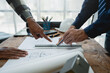 © crizzystudio - Team of engineers reviewing blueprints Sketch of a new construction project with engineering tools at office desk. For improvement of house designs in mortgage, rent, sale, real estate