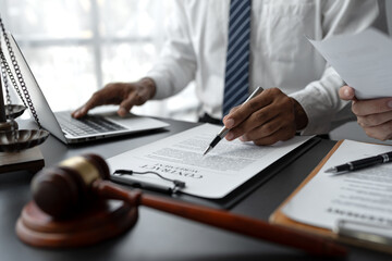 Businessmen or lawyers working together at a meeting, teamwork and partnership. Signing documents, contracts, checking details business agreement