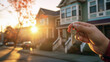 © Majed - hand holding apartment keys in street with
