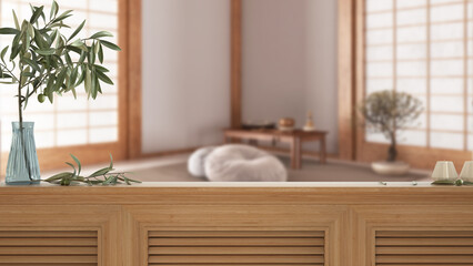 Wooden table top, cabinet, panel or shelf with shutters close up. Olive branch in vase and candles. Blurred background with white minimal meditation room