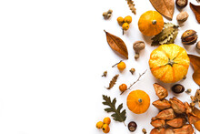 Autumn Creative Composition Made Of Pumpkins, Dried Leaves, Chestnuts And Acorns On White Background