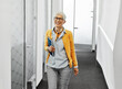 © Lumos sp - business businesswoman senior elderly office meeting woman portrait corporate manager smiling walking hallway corridor happiness mature glasses career job break executive