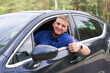 © Евгений Шемякин - Young happy man with his new car show thumb up, like gesture with finger. Satisfied customer, driver.
