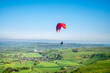 A man para gliding in Peak District national park UK