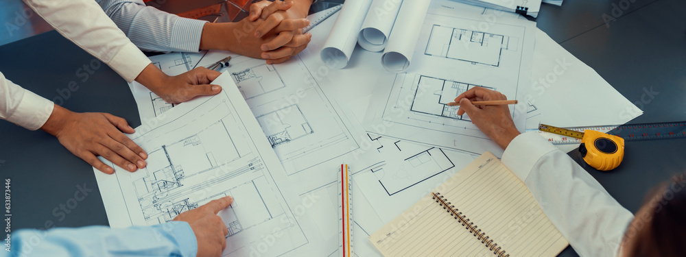 Engineer partner drawing and working on blueprint design together on ...