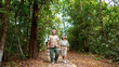 © CandyRetriever  - Asian senior couple relax and enjoy outdoor lifestyle travel nature hiking together at tropical forest trail on summer vacation. Retired elderly people leisure activity and mental health care concept.