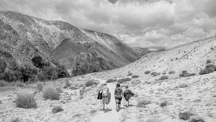 Sticker - People walking in the countryside. Black and white toned image 