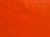 Fototapeta  - Red-orange stucco texture background in Oaxaca, Mexico