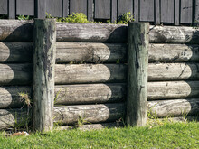 Cantilever Wooden Half Rounds Pole Retaining Wall. For Residential Sites.