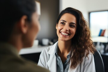 a smiling female doctor in a doctors office with a patient