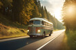 Shot of a retro-style travel bus driving on a country road in the early morning.