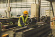 © Quality Stock Arts - Hispanic Latin Indian male professional tecnician worker working with steel precision milling machine in lathe metal factory