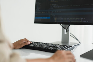 hands of developer programmer using mouse and typing on keyboard to programming and developing web