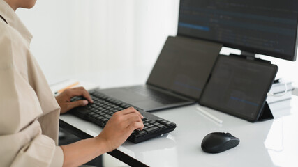 Developer programmer working about programming code to developing web and apps on multiple monitor