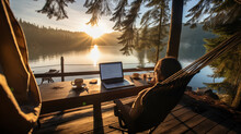A Sunlit, Serene, Lakeside Setup In British Columbia: A Digital Nomad Working On A Laptop, Sitting In A Hammock, Surrounded By Towering Pine Trees, A Steaming Cup Of Coffee On A Wooden Table Nearby