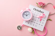 Educate and advocate during International Breast Cancer Awareness Month. Top view photo of calendar, stethoscope, clock and pink ribbon on pastel pink backdrop, suitable for text or advertising