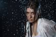 © Ulia Koltyrina - young woman in the rain, getting wet through, wet clothes and water running down her face. Emotional portrait close-up in aqua studio