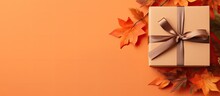Top View Of Fall Themed Handmade Paper Gift Box On Orange Background With Copy Space