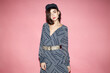 © Sergey Chumakov - fashion model in striped dress and vintage cap isolated on pink background