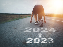 White Arrow And Text 2023 To 2024 On Asphalt Road A Runner Who Is Preparing To Run Forward Entering The New Year New Beginning