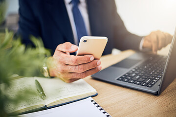 Phone, laptop and a business person with internet for research, information technology or contact. Hands of a professional man with a smartphone and notebook for planning, schedule or communication