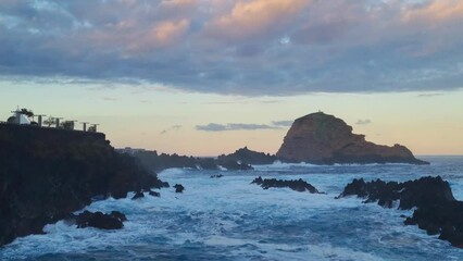 Wall Mural - Large waves of the ocean wash the coast and break on the rocks