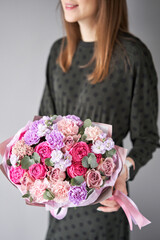 Wall Mural -  Florist woman creates beautiful bouquet of mixed flowers. European floral shop concept. Handsome fresh bunch. Education, master class and floristry courses. Flowers delivery.