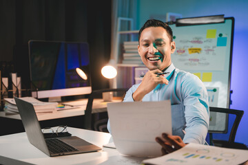business man working late at night use laptop at desk happy male portrait working it, face and male 