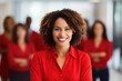 © Maryann - group of people standing in office, confident black woman wearing red leading corporate team with confidence
